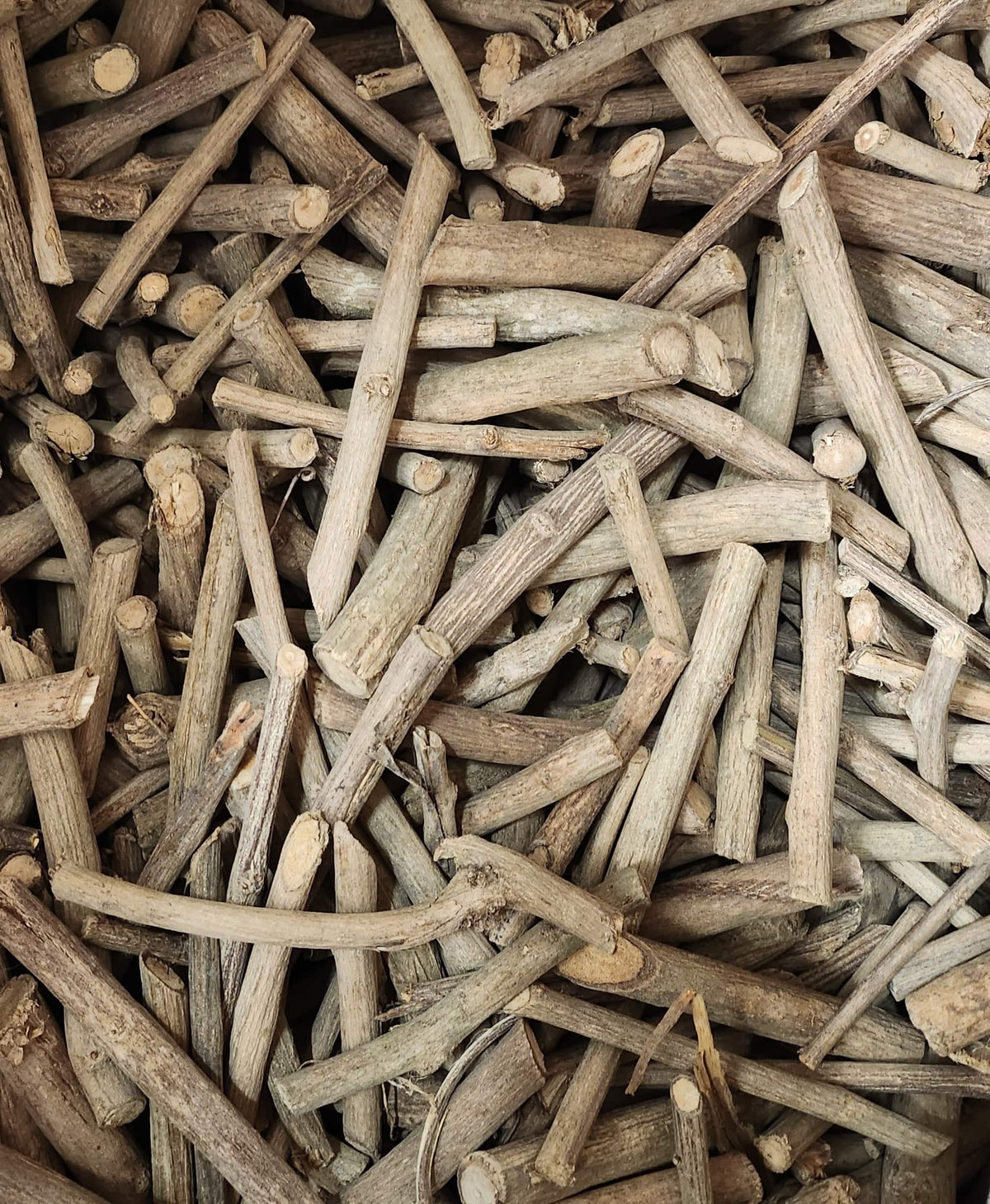 Natural Miswak chew stick from Herbal Island, showing a wooden stick used for dental hygiene and oral health.