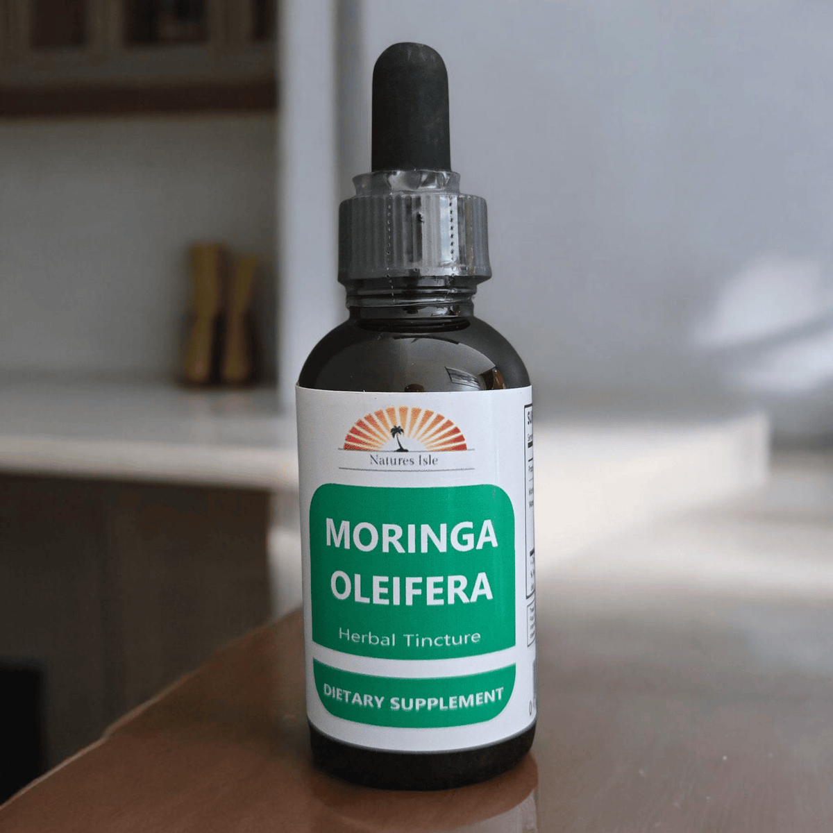 Herbal Island Moringa Oleifera tincture in a glass dropper bottle, liquid supplement with a white and green label.